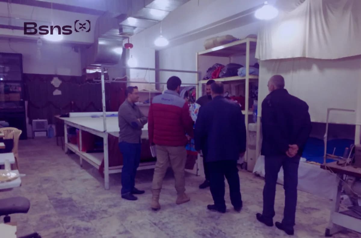 Business X team on a site visit inside a workshop