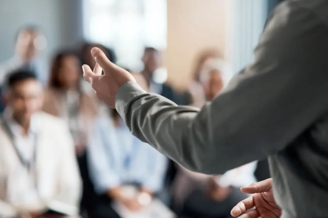 A speaker addressing an audience in a training session