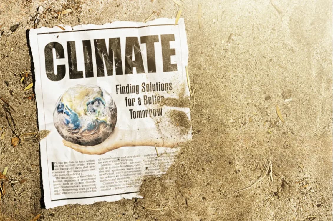 A newspaper page headed Climate lying on dry earth